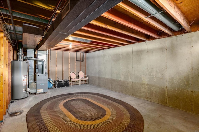 unfinished basement with gas water heater and heating unit