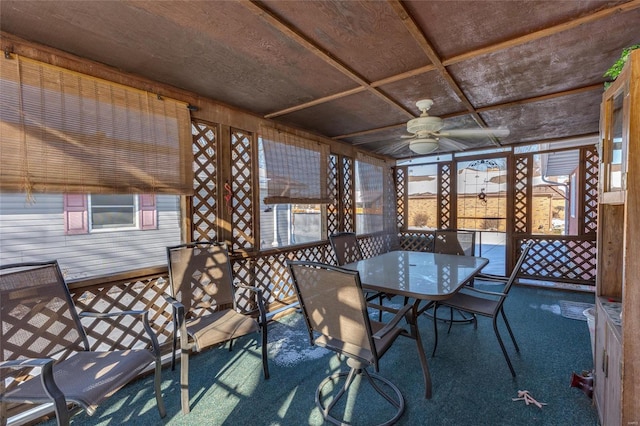 unfurnished sunroom with a ceiling fan