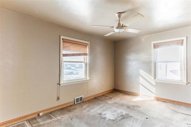 spare room with light colored carpet and ceiling fan