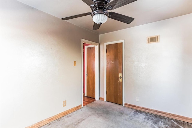 spare room with ceiling fan and light carpet