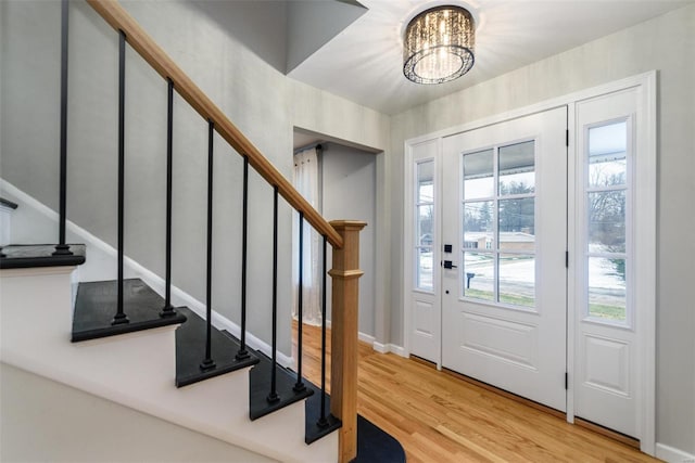 entrance foyer with a notable chandelier and light hardwood / wood-style floors