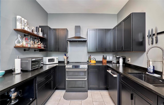 kitchen featuring appliances with stainless steel finishes, sink, wall chimney exhaust hood, and light tile patterned floors