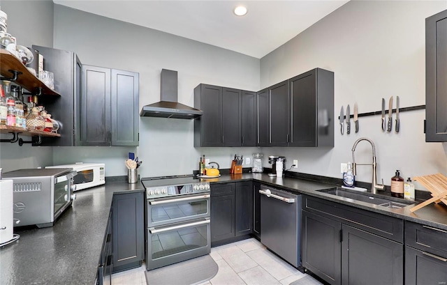 kitchen featuring sink, wall chimney range hood, and appliances with stainless steel finishes