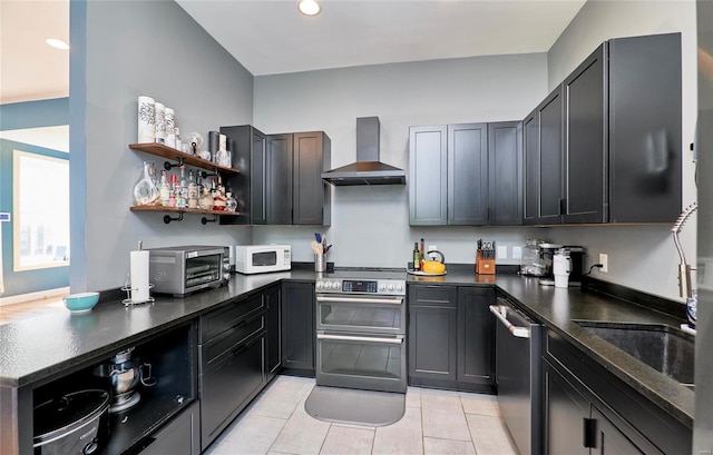 kitchen featuring stainless steel appliances, wall chimney exhaust hood, light tile patterned floors, and sink