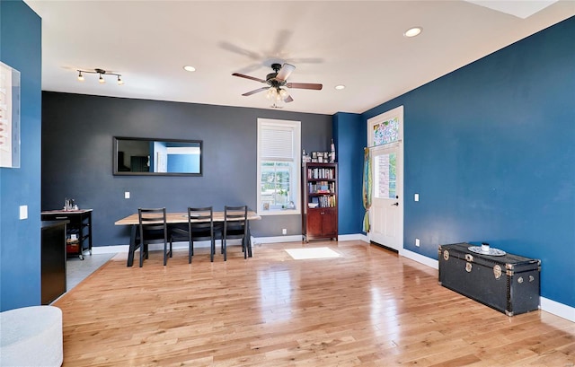 dining room with light hardwood / wood-style floors and ceiling fan