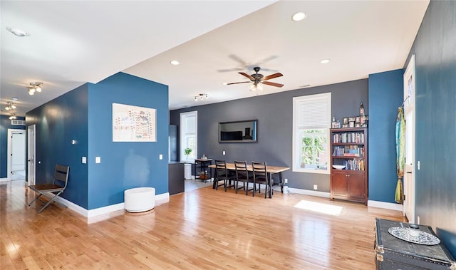 interior space with ceiling fan and light hardwood / wood-style floors