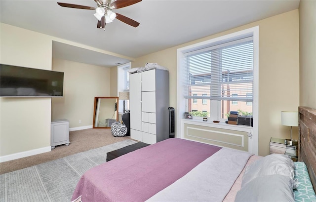 carpeted bedroom featuring ceiling fan and multiple windows