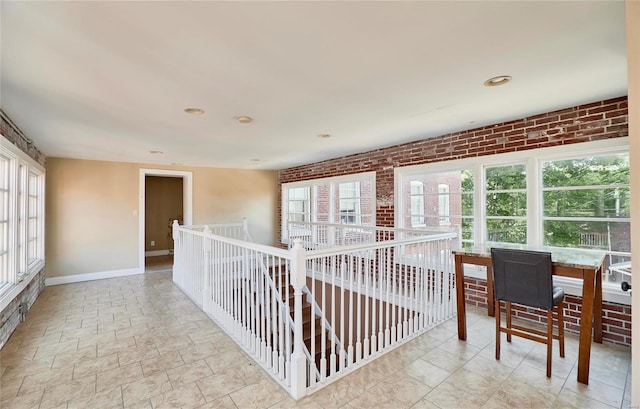 corridor with brick wall and a wealth of natural light