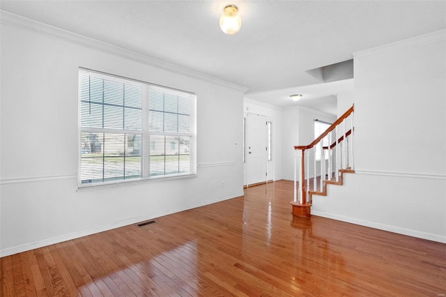 interior space featuring hardwood / wood-style flooring and ornamental molding