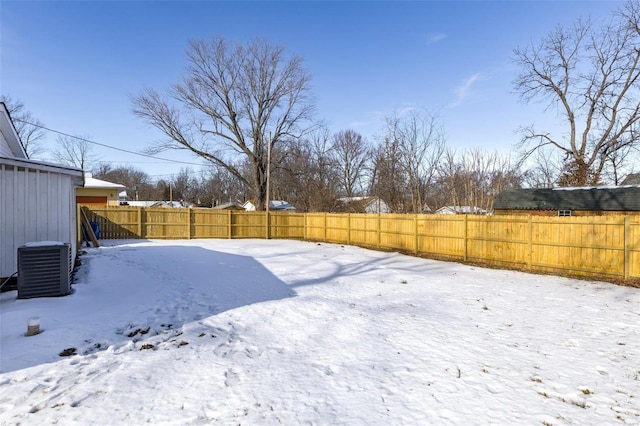 snowy yard featuring central AC unit