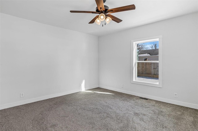 carpeted spare room featuring ceiling fan