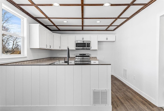 kitchen featuring dark hardwood / wood-style floors, sink, coffered ceiling, white cabinetry, and appliances with stainless steel finishes