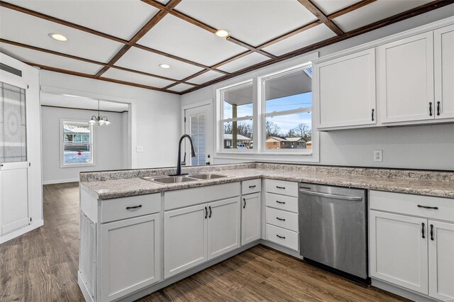 kitchen featuring dark hardwood / wood-style floors, stainless steel dishwasher, sink, coffered ceiling, and white cabinets