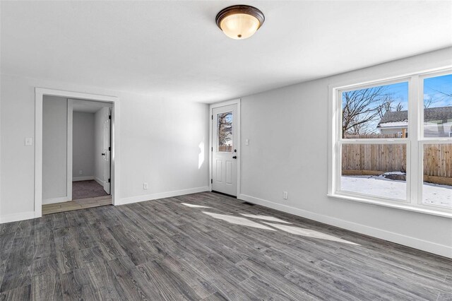 empty room featuring dark hardwood / wood-style flooring