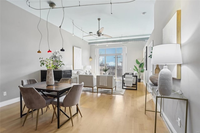 dining room featuring light wood finished floors and baseboards