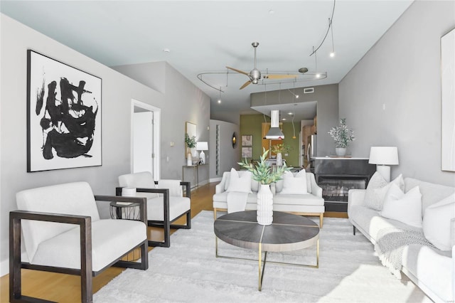 living area with light wood-style flooring and visible vents