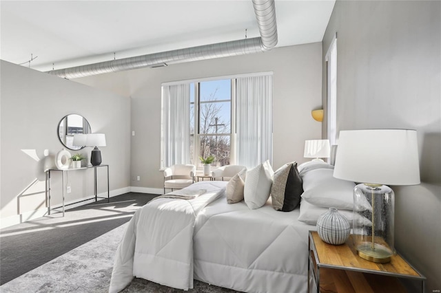 bedroom featuring carpet floors and baseboards