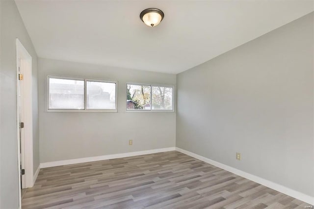 unfurnished room with light hardwood / wood-style floors