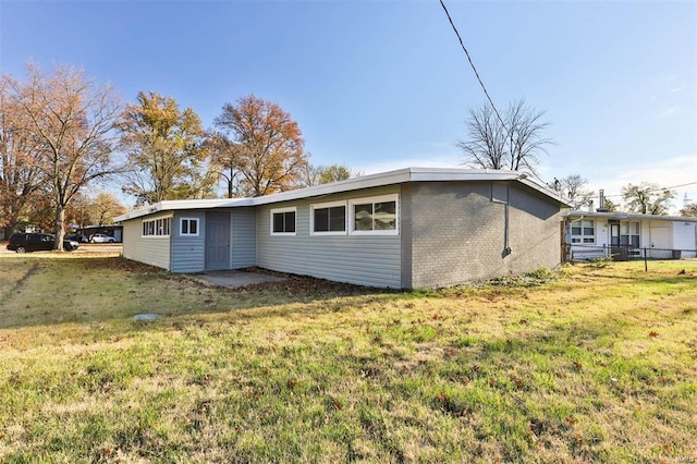 rear view of house featuring a yard