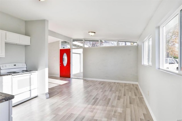 kitchen featuring white cabinetry, electric range, and light hardwood / wood-style floors