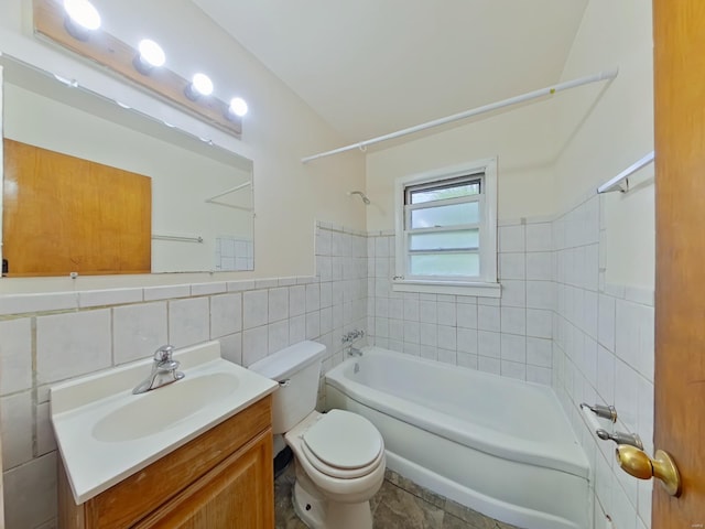 full bathroom with toilet, vanity, tile walls, and washtub / shower combination