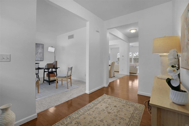 hallway with hardwood / wood-style flooring