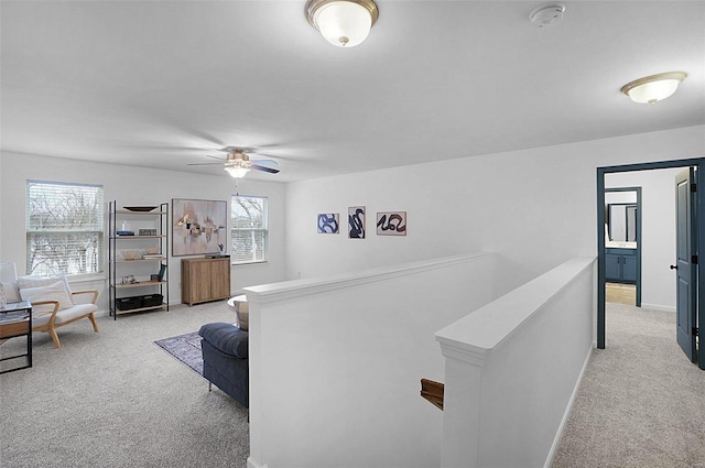 carpeted living room with ceiling fan