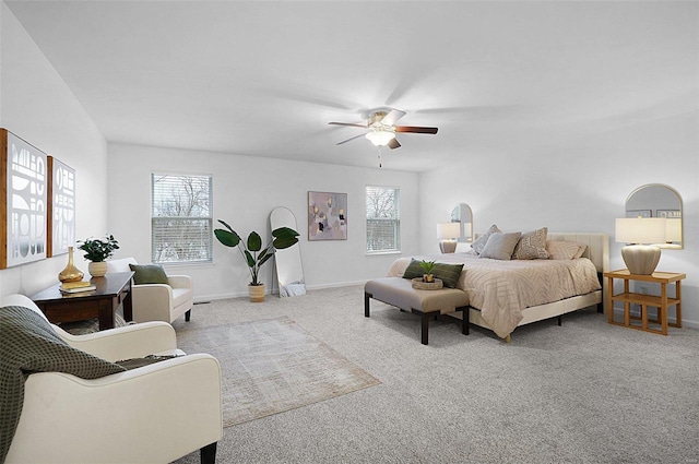 carpeted bedroom featuring ceiling fan and multiple windows