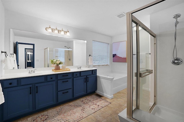 bathroom featuring shower with separate bathtub, tile patterned floors, and vanity