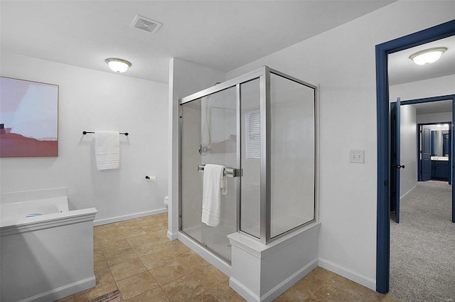 bathroom featuring walk in shower, vanity, and toilet