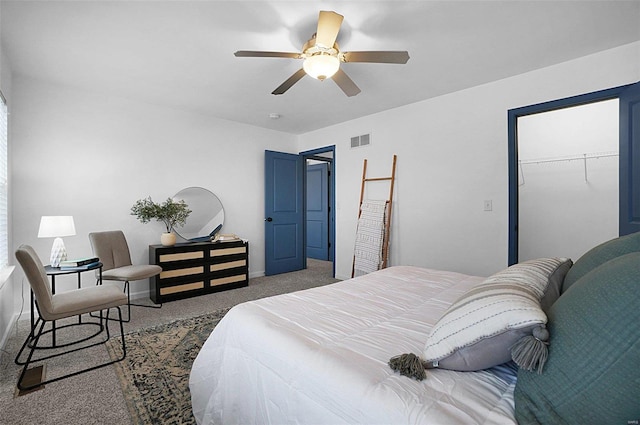 bedroom with ceiling fan, carpet, and a closet