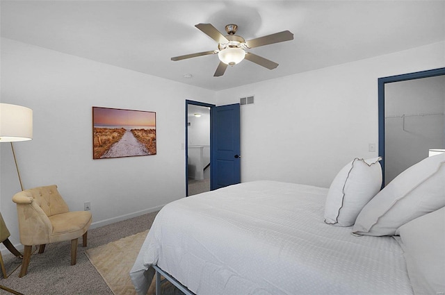 bedroom featuring ceiling fan, light colored carpet, a closet, and a spacious closet