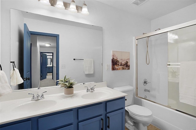 full bathroom featuring combined bath / shower with glass door, vanity, and toilet