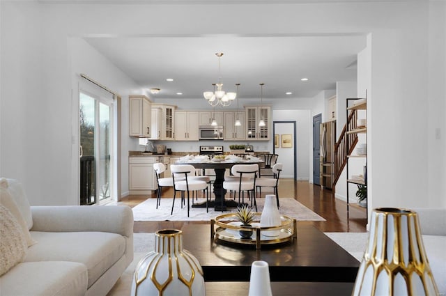 living room featuring light wood-type flooring and an inviting chandelier