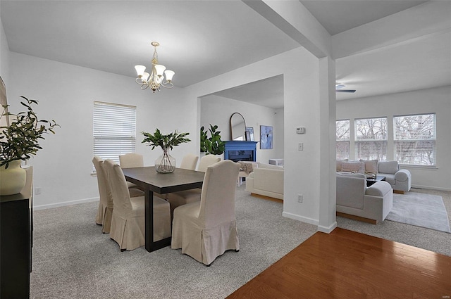 dining room featuring beam ceiling, a notable chandelier, and light wood-type flooring