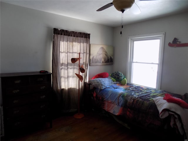 bedroom with ceiling fan and dark wood-type flooring