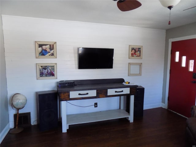 living room featuring ceiling fan and dark hardwood / wood-style flooring