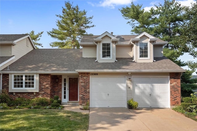 view of front of property featuring a garage and a front lawn