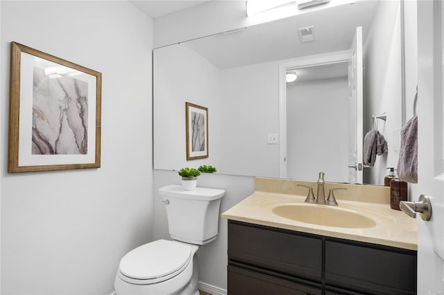 bathroom featuring toilet and vanity