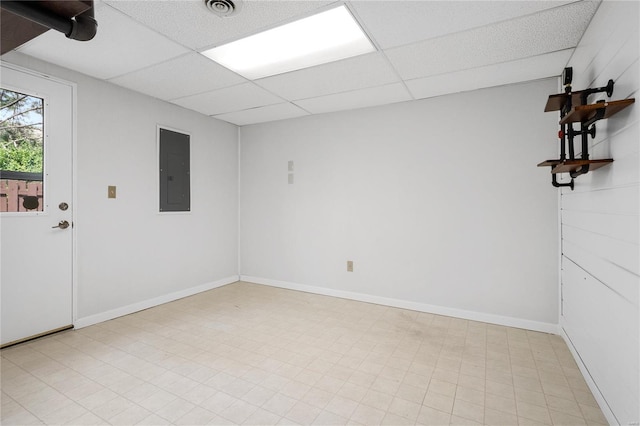 spare room featuring electric panel and a drop ceiling