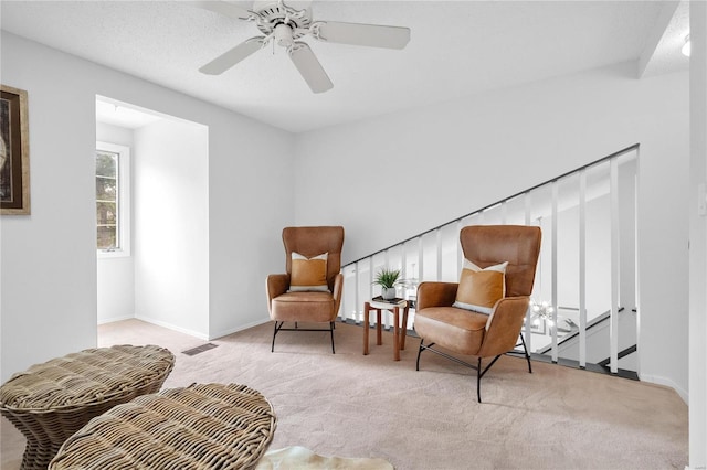 sitting room featuring ceiling fan and light carpet