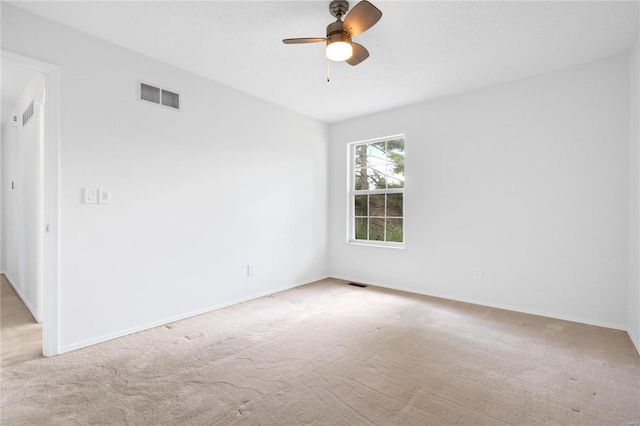 carpeted spare room featuring ceiling fan