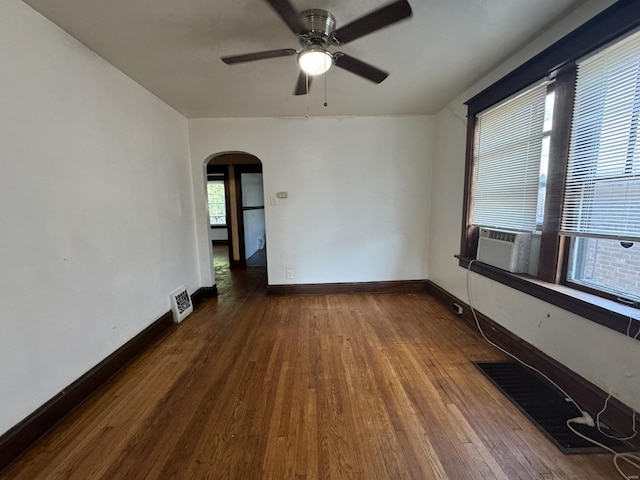 spare room with cooling unit, dark hardwood / wood-style flooring, and ceiling fan