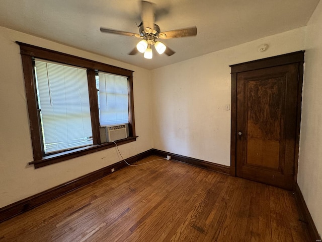 unfurnished room featuring cooling unit, ceiling fan, plenty of natural light, and dark hardwood / wood-style floors