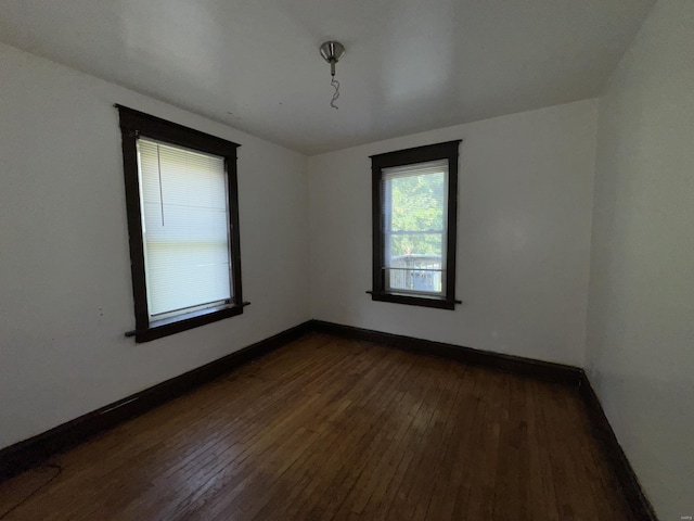 spare room with dark hardwood / wood-style flooring