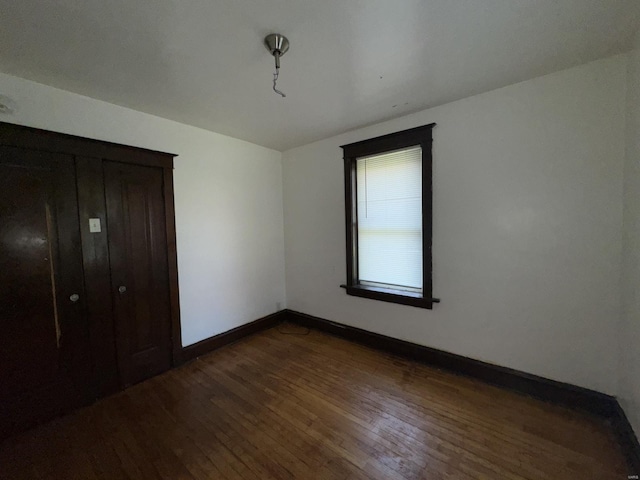 unfurnished bedroom featuring dark wood-type flooring