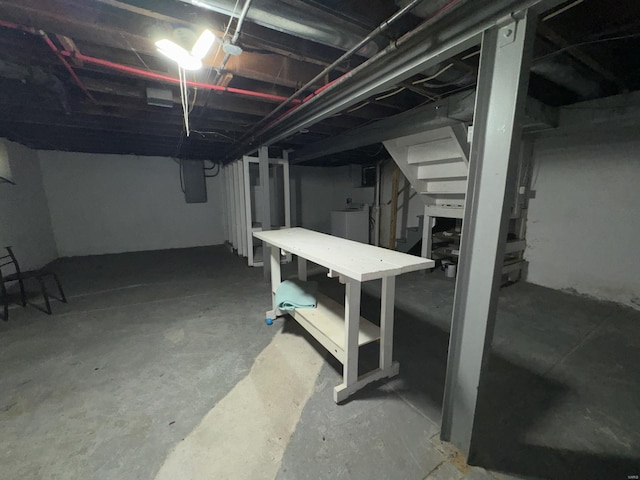 basement with electric panel and washer / clothes dryer