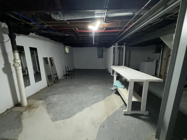 basement with electric panel and washer / clothes dryer