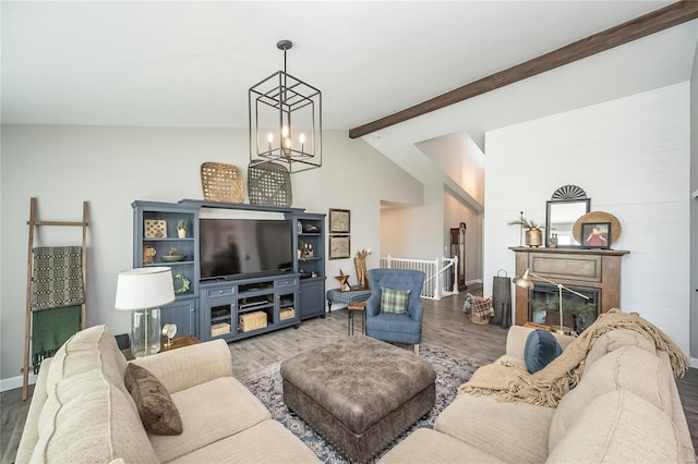 living room featuring hardwood / wood-style floors, lofted ceiling with beams, and a notable chandelier