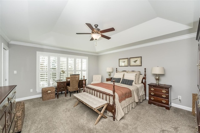 bedroom with ceiling fan, a tray ceiling, crown molding, and carpet flooring